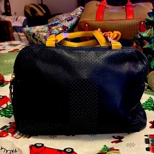 Isaac Mizrahi of New York bag.  Navy blue bag with tan handles gently handles.